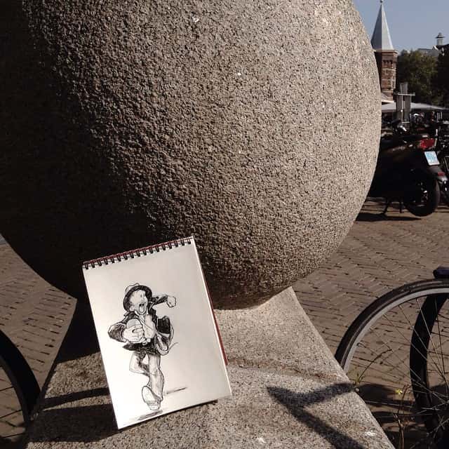 He turns a normal scene into a story by adding hand drawn characters.