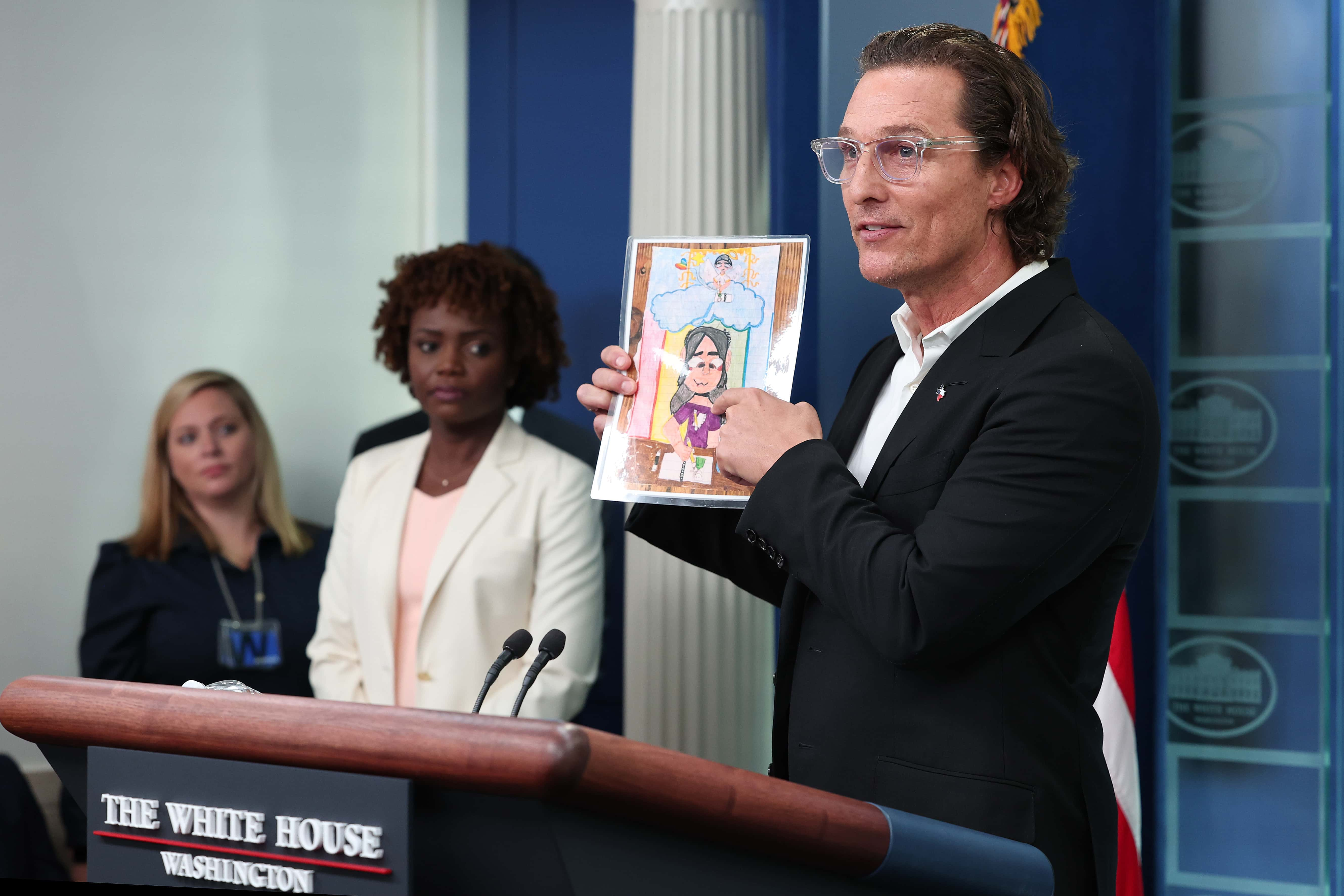 WASHINGTON, DC - JUNE 07: After meeting with President Joe Biden, Actor Matthew McConaughey holds up artwork by one of the victims of the school shooting in Uvalde, Texas, during the daily news conference in the Brady Press Briefing Room at the White House on June 07, 2022 in Washington, DC. (Photo by Win McNamee/Getty Images)
