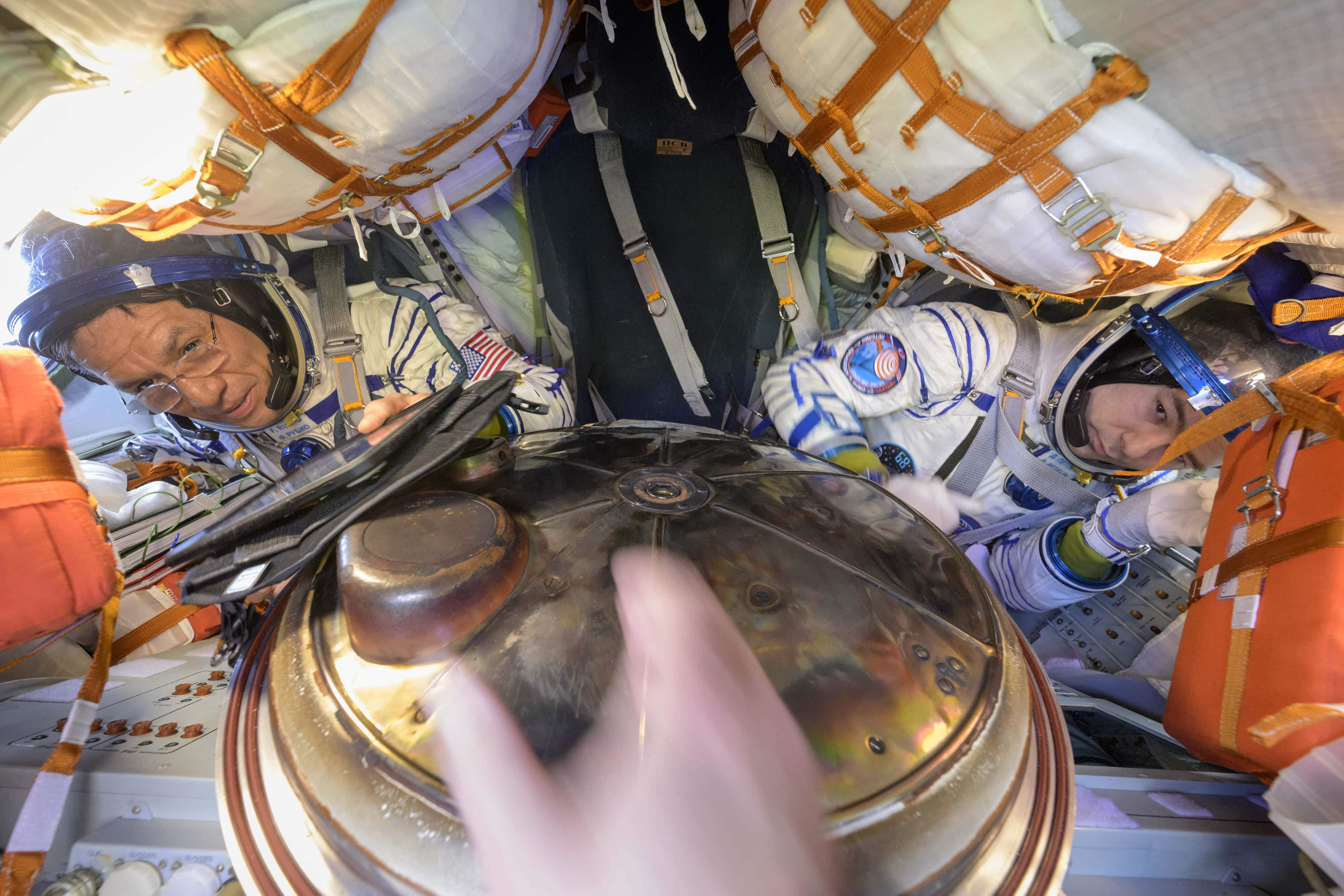 Image Source: Frank Rubio (L) and Roscosmos cosmonaut Dmitri Petelin are seen inside the Soyuz MS-23 spacecraft just minutes after they and Roscosmos cosmonaut Sergey Prokopyev, landed in a remote area near the town of Zhezkazgan, Kazakhstan on September 27, 2023. (Photo by Bill Ingalls/NASA via Getty Images)