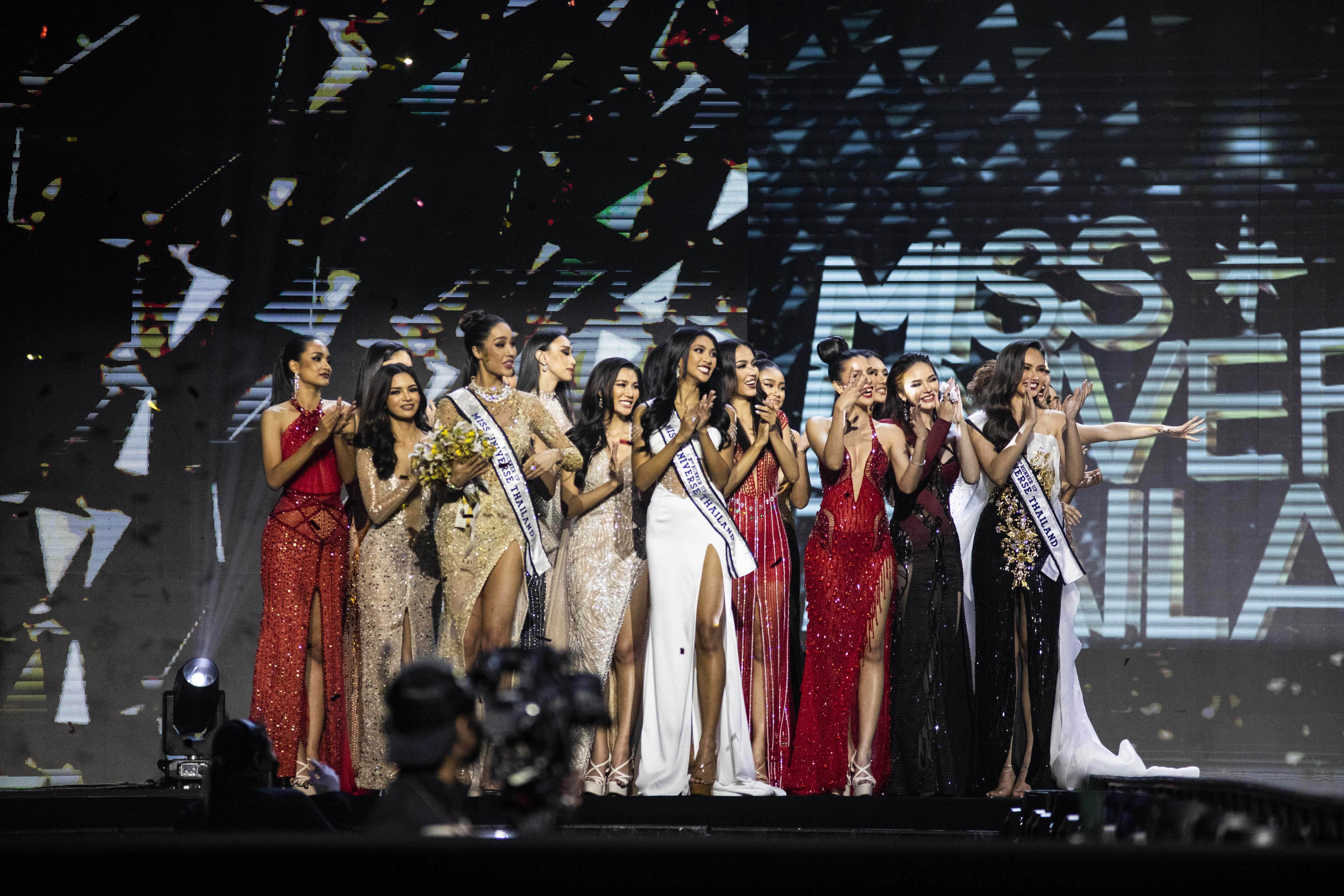 Image Source: Anchilee Scott-Kemmis is congratulated by her fellow contestants after winning the 22nd Miss Universe Thailand pageant at Nong Nooch Tropical Garden on October 24, 2021 in Pattaya, Thailand. The annual pageant, held at a botanical garden this year, determines the Thai representative for the global Miss Universe competition. Social distancing measures are in place with pre-event COVID-19 testing required for all attendees. (Photo by Lauren DeCicca/Getty Images)