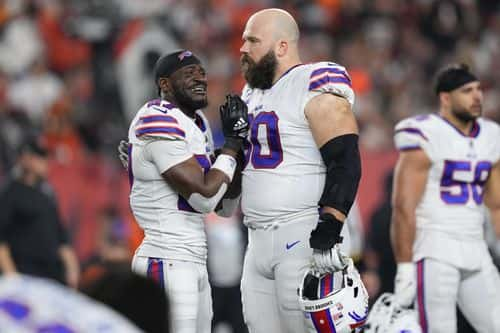 Tre'Davious White #27 and Mitch Morse #60 of the Buffalo Bills react after teammate Damar Hamlin #3 was injured against the Cincinnati Bengals - Getty Images | Timothy T Ludwig