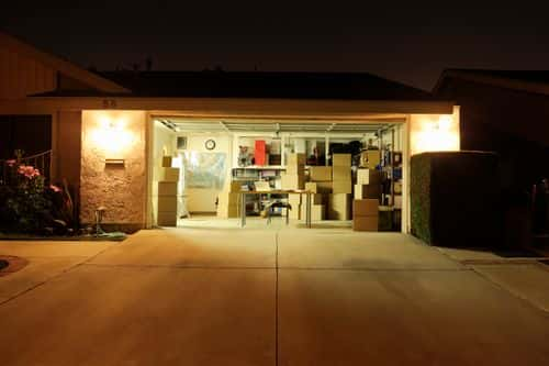 Illuminated garage with open door. Getty Images / Maguey Images 