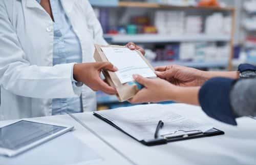 Closeup shot of an unrecognizable pharmacist assisting a customer in a chemist - Getty Images | Hiraman